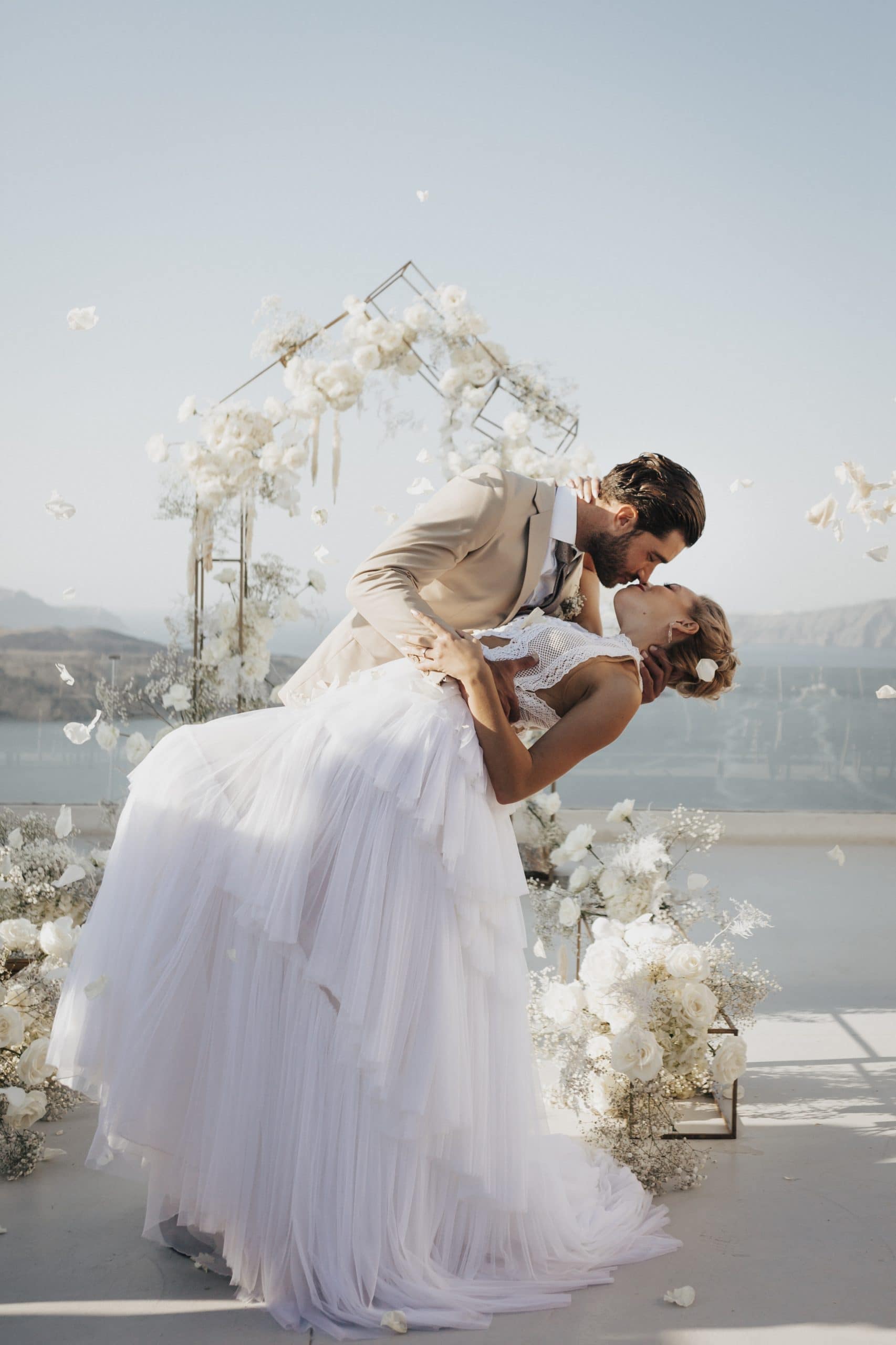 A Santorini wedding photograph of a couple against the caldera