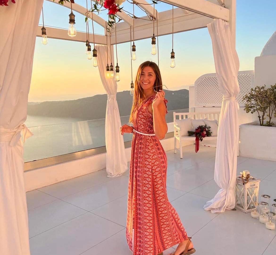 Smaragda, wedding and event planner at Emerald Events, on a terrace in Santorini at sunset