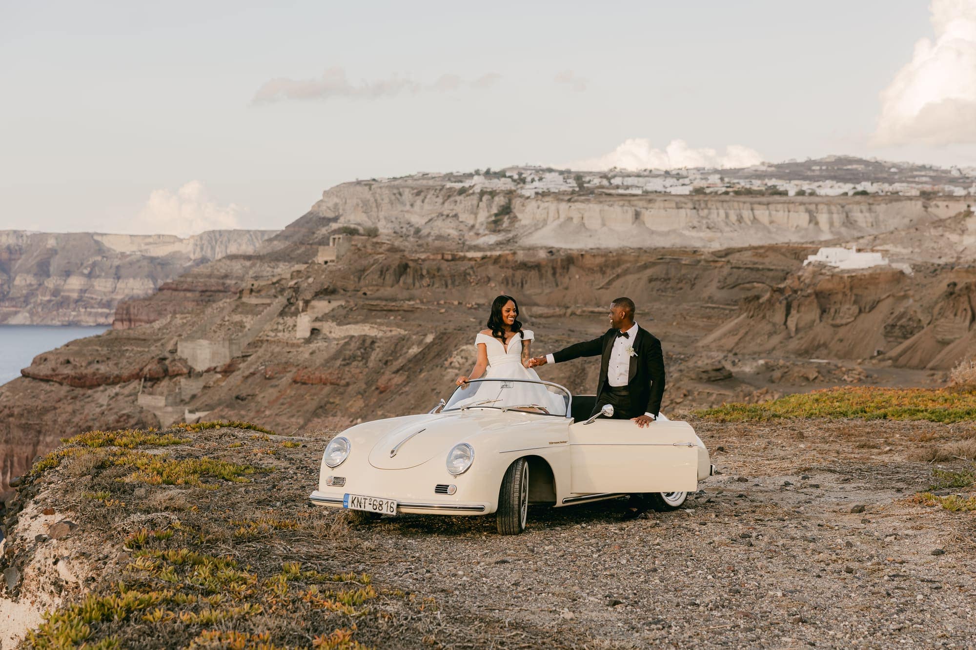Irlon & Jailleen — sunset portraits with a vintage convertible on the caldera rim, Caldera terrace, Santorini