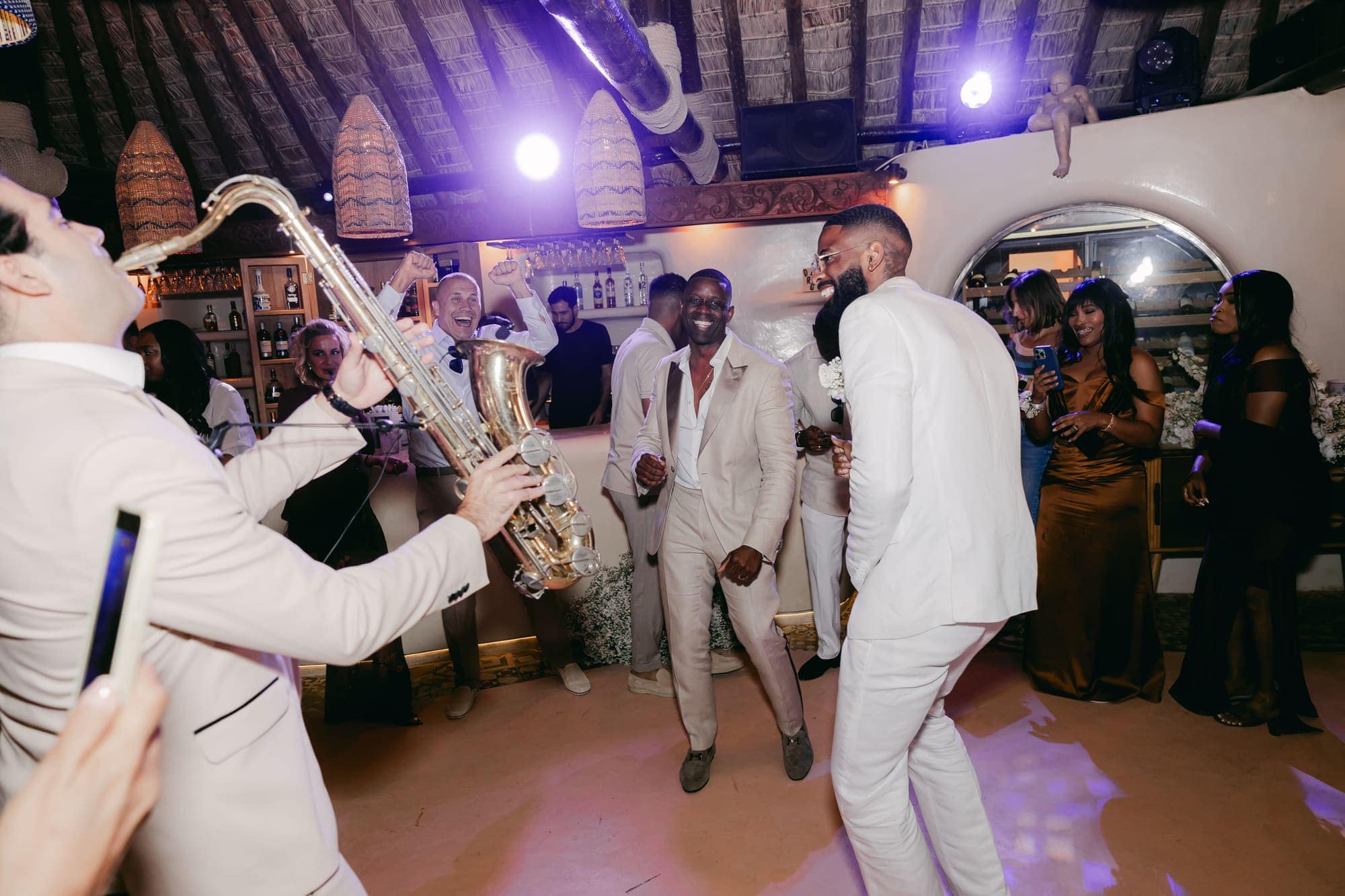 Irlon & Jailleen — fireworks and the saxophone as the party begins, Caldera terrace, Santorini