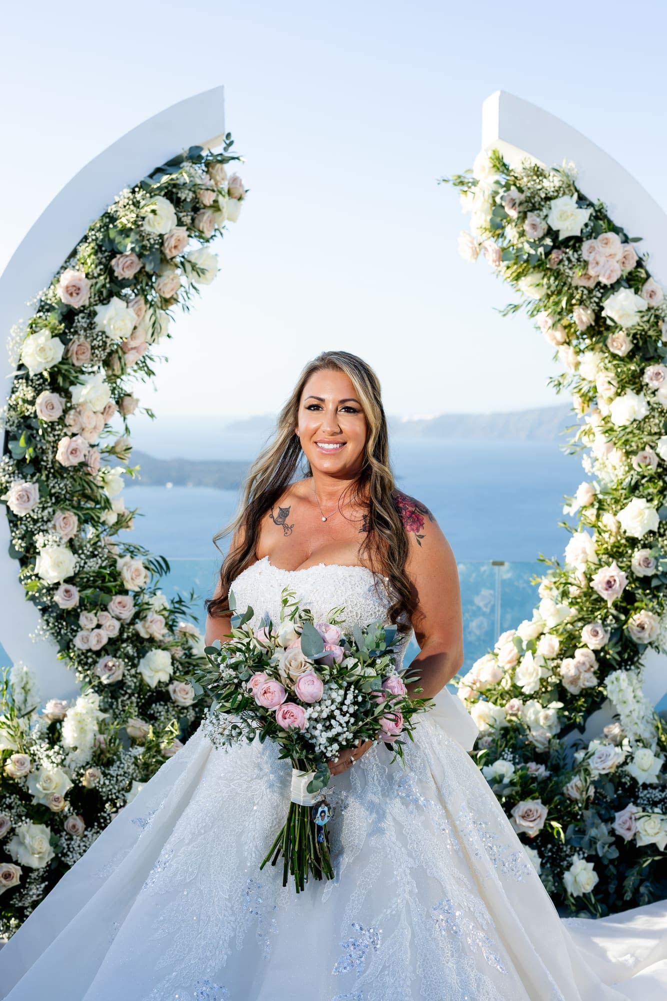 Mary & Chris — portraits at the crescent arch above the caldera, Windmill venue on the caldera, Santorini