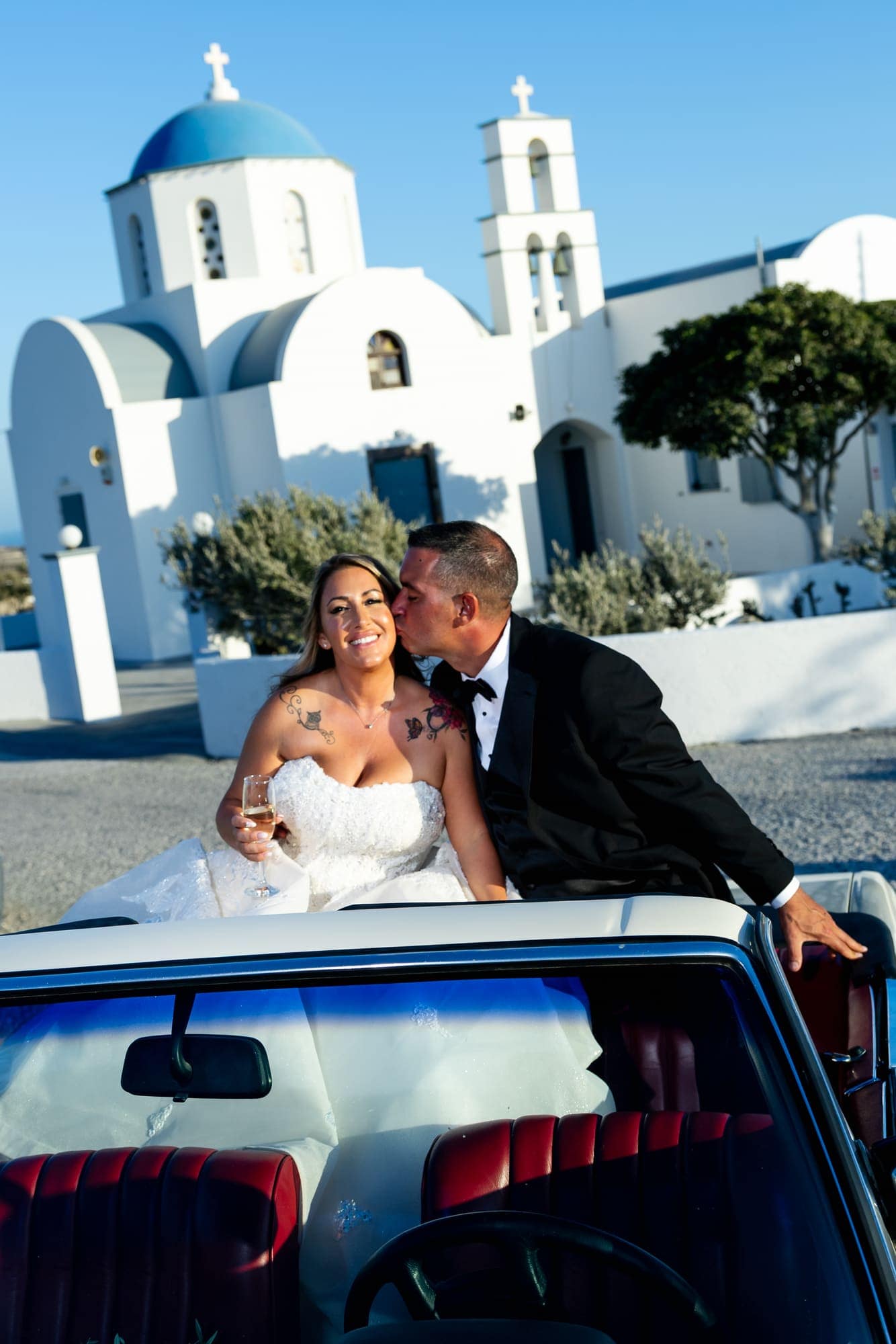 Mary & Chris — the vintage convertible and the blue-domed church, Windmill venue on the caldera, Santorini
