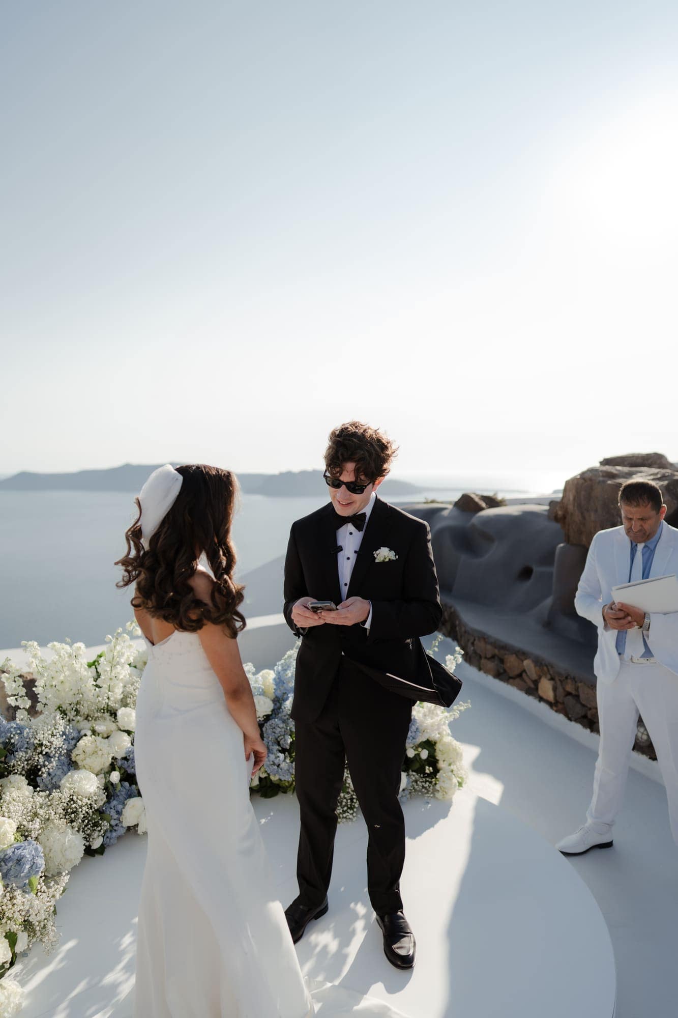 Tina & Kanon — the ceremony and the exchange of vows, Cliffside terrace, Santorini