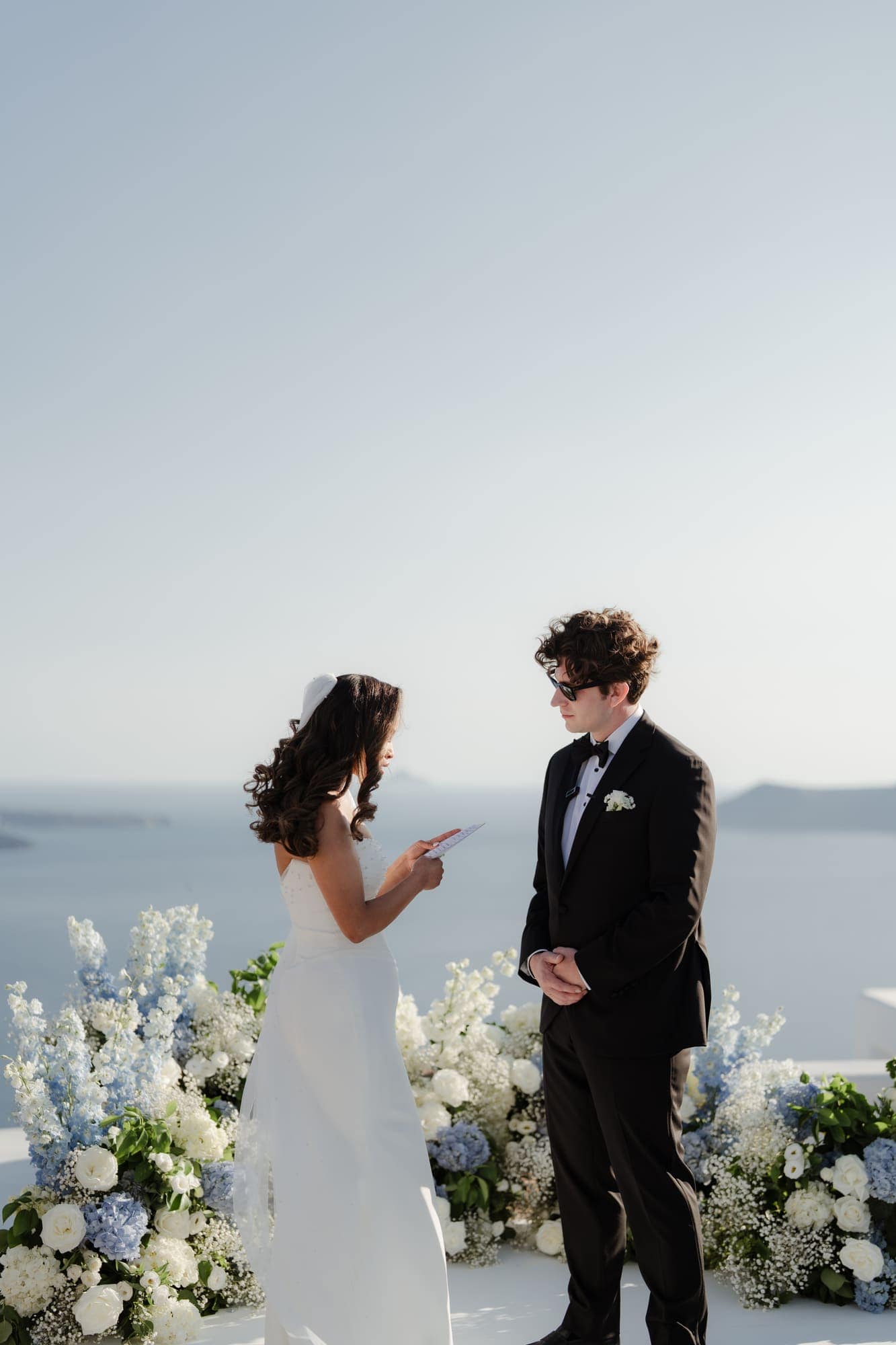Tina & Kanon — the ceremony and the exchange of vows, Cliffside terrace, Santorini
