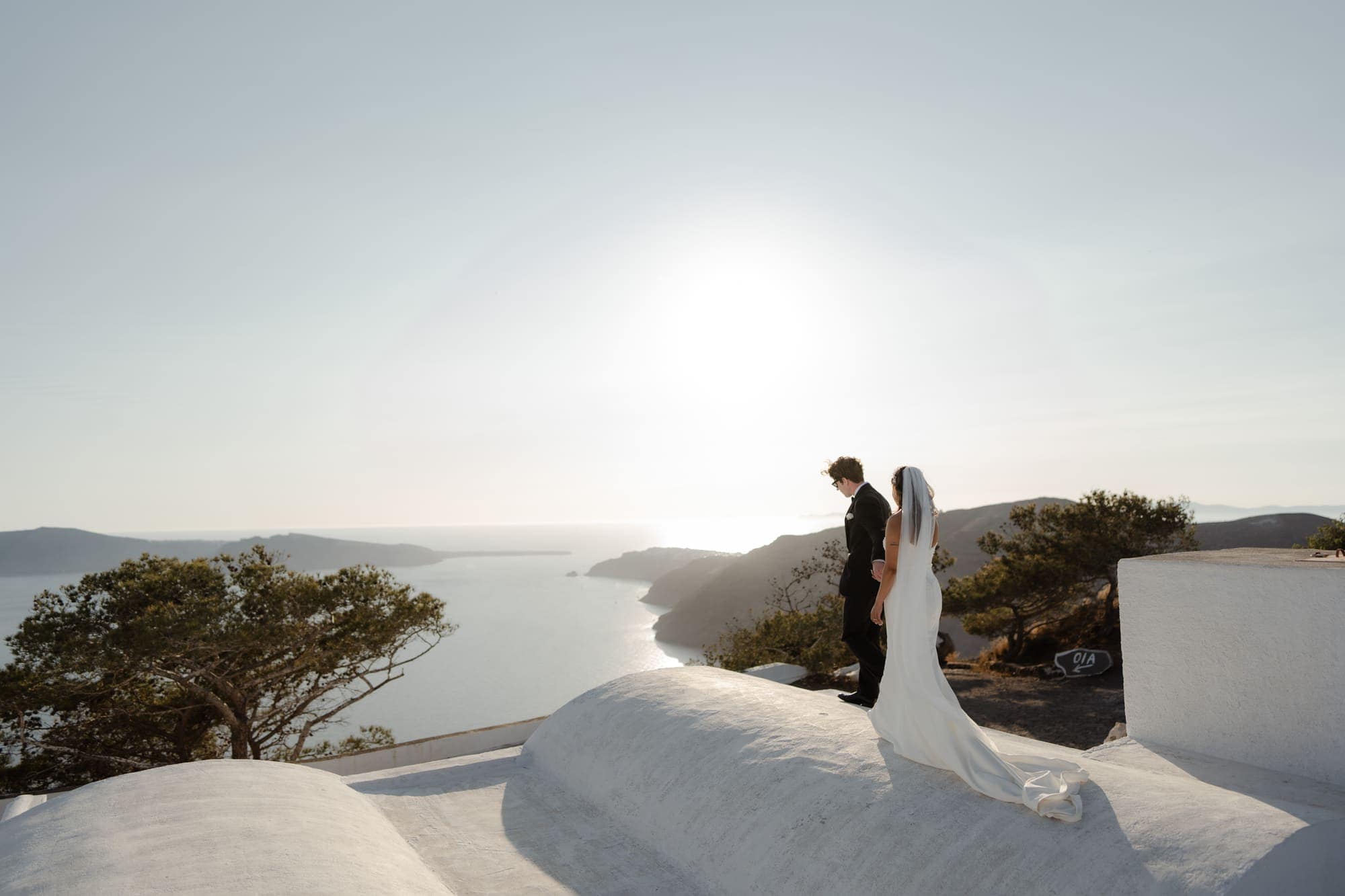 Tina & Kanon — golden hour on the whitewashed terraces, Cliffside terrace, Santorini