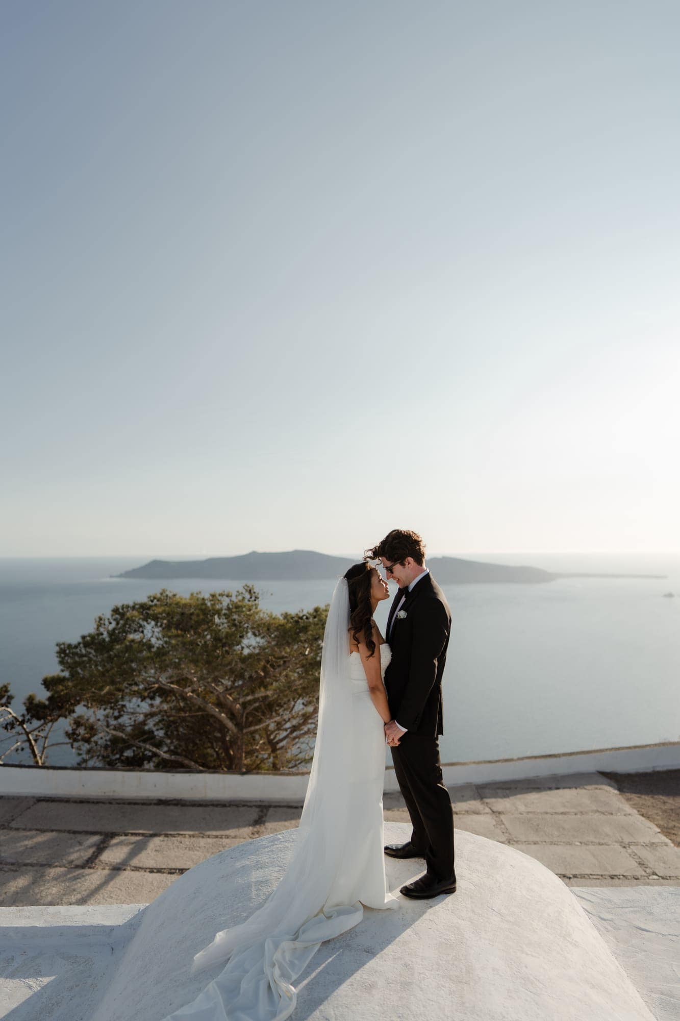 Tina & Kanon — golden hour on the whitewashed terraces, Cliffside terrace, Santorini