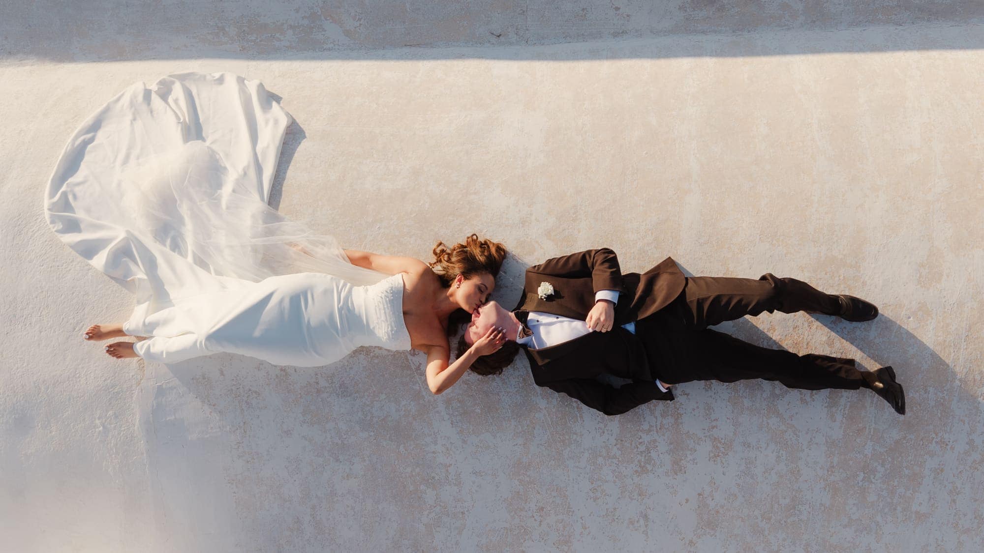 Tina & Kanon — golden hour on the whitewashed terraces, Cliffside terrace, Santorini